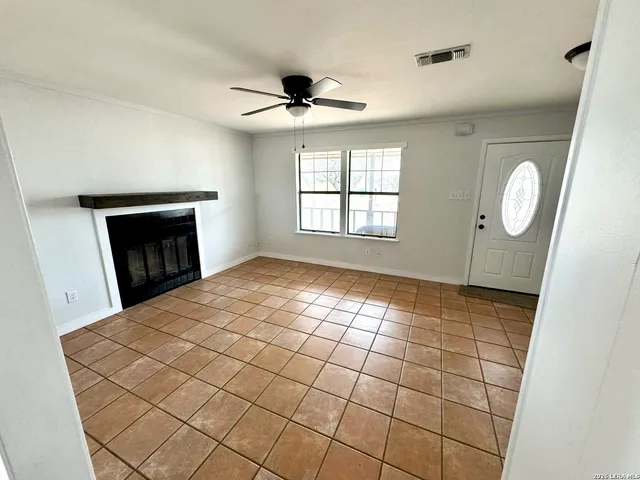 a view of empty room with window and fireplace