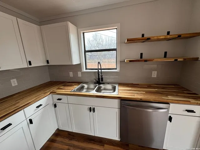 a kitchen with appliances cabinets and a sink