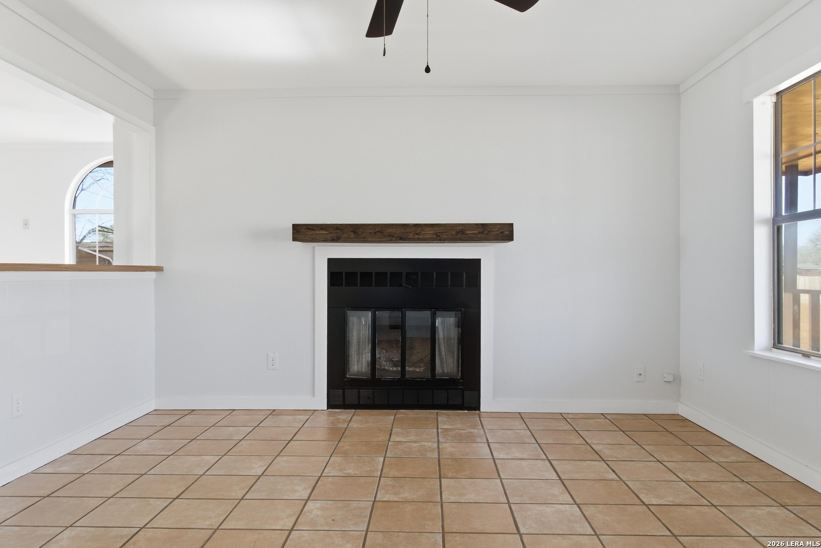 910 Cypress Street Jourdanton, TX 78026 - Photo 6 of 25 a view of an empty room and window