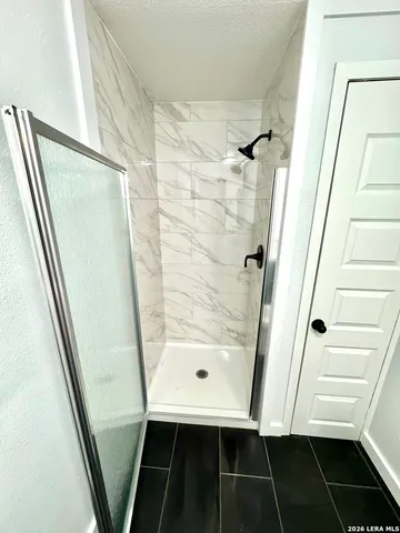 a bathroom with a shower and a mirror