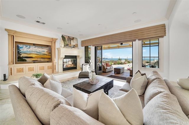 a view of a patio with couches and a table and chairs with garden view