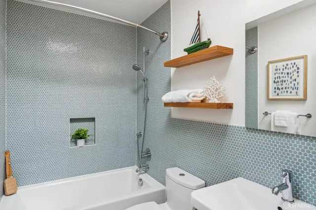 a bathroom with a toilet and a shower curtain