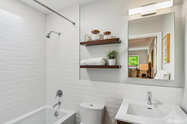 a bathroom with a sink a toilet and shower curtain