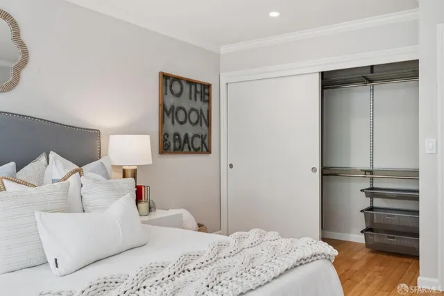 a bedroom with a bed and a night stand