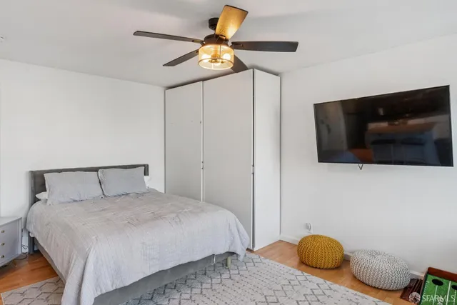 a bedroom with a bed and flat screen tv