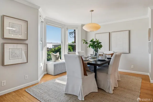 a dining room with furniture and window