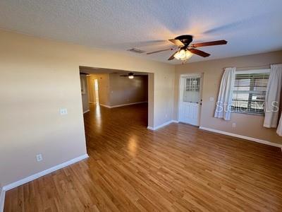 9759 Southwest 97th Lane Ocala, FL 34481 - Photo 12 of 28 a view of an empty room with wooden floor and a window