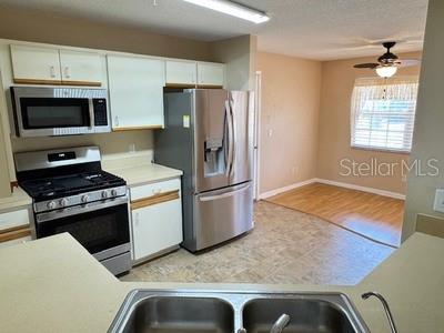 9759 Southwest 97th Lane Ocala, FL 34481 - Photo 13 of 28 a kitchen with stainless steel appliances granite countertop a refrigerator and a stove top oven