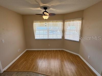 9759 Southwest 97th Lane Ocala, FL 34481 - Photo 16 of 28 a view of an empty room with wooden floor and a window