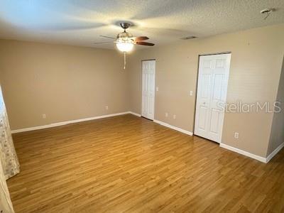 9759 Southwest 97th Lane Ocala, FL 34481 - Photo 18 of 28 a view of an empty room with wooden floor