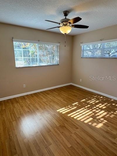 9759 Southwest 97th Lane Ocala, FL 34481 - Photo 23 of 28 a view of a room with wooden floor and fan