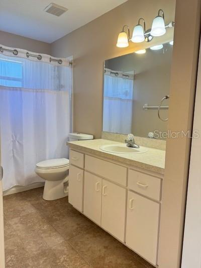 9759 Southwest 97th Lane Ocala, FL 34481 - Photo 25 of 28 a bathroom with a double vanity sink mirror and toilet