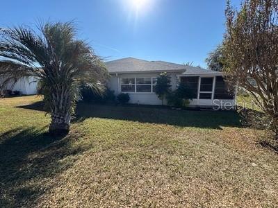 9759 Southwest 97th Lane Ocala, FL 34481 - Photo 28 of 28 a front view of house with yard and trees