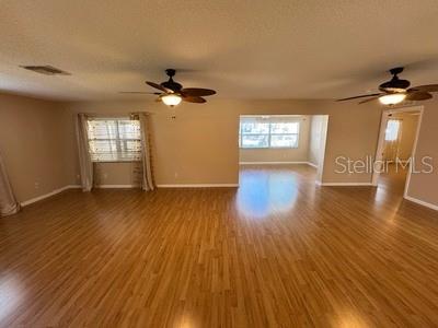 9759 Southwest 97th Lane Ocala, FL 34481 - Photo 5 of 28 a view of an empty room with window and wooden floor