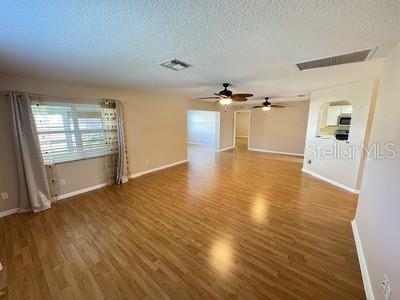 9759 Southwest 97th Lane Ocala, FL 34481 - Photo 8 of 28 an empty room with wooden floor and windows