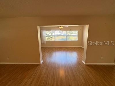 9759 Southwest 97th Lane Ocala, FL 34481 - Photo 10 of 28 an empty room with wooden floor and windows