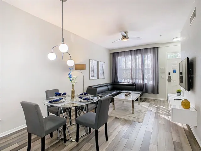 a view of a dining room with furniture and wooden floor