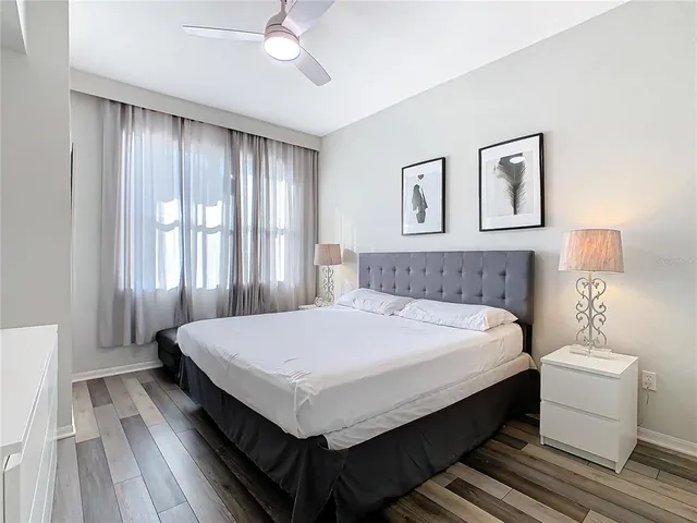 a bedroom with a large bed and a chandelier