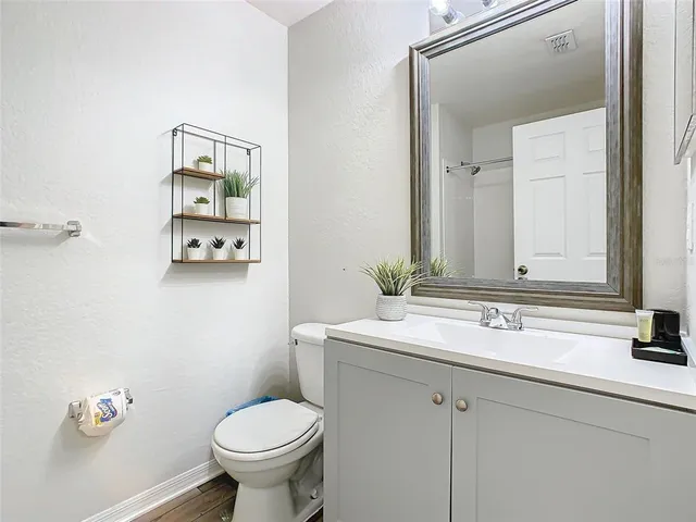 a bathroom with a sink toilet and a mirror