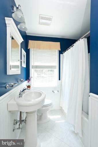 182 Brandon Road Baltimore, MD 21212 - Photo 25 of 30 a bathroom with a sink a toilet and a mirror