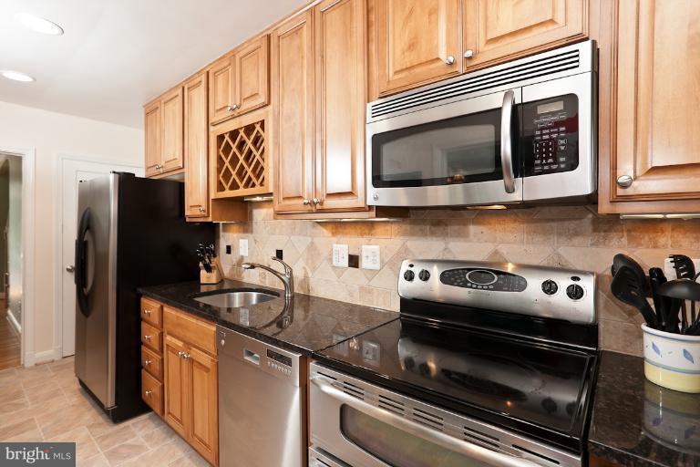 182 Brandon Road Baltimore, MD 21212 - Photo 28 of 30 a kitchen with stainless steel appliances granite countertop a stove microwave and refrigerator