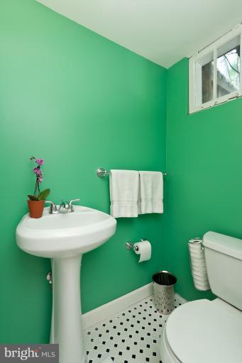 182 Brandon Road Baltimore, MD 21212 - Photo 8 of 30 a bathroom with a sink toilet and mirror