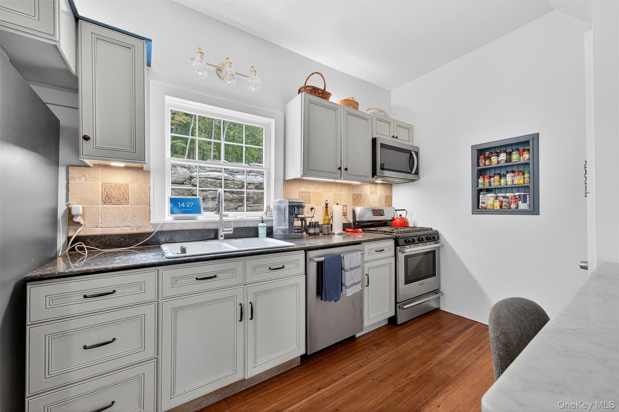 1657 River Road Damascus, PA 18415 - Photo 18 of 43 a kitchen with granite countertop a stove a sink and a microwave