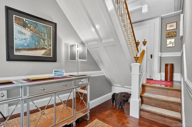 a view of a hallway with workspace and stairs