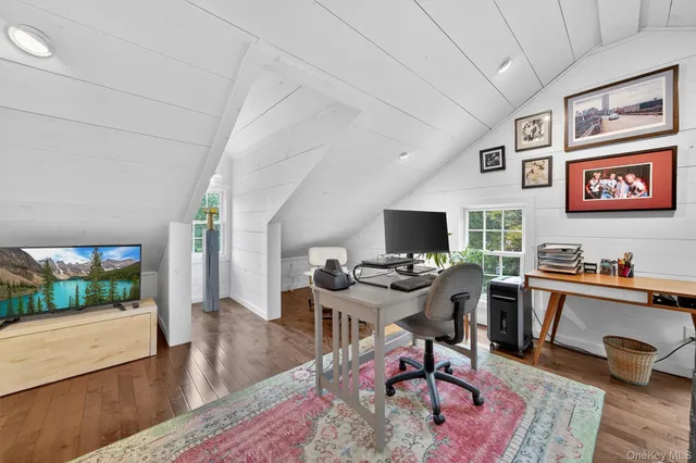 a workspace with furniture and a wooden floor