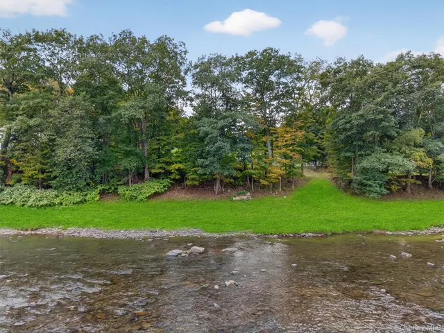 a green field with lots of trees