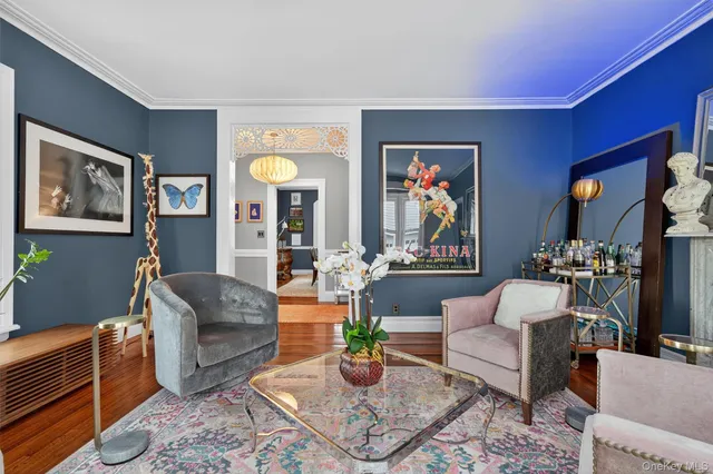 a living room with furniture and painting on the wall