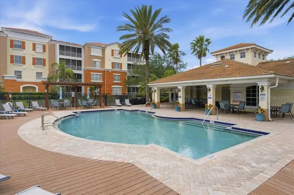 a view of a house with swimming pool and sitting area