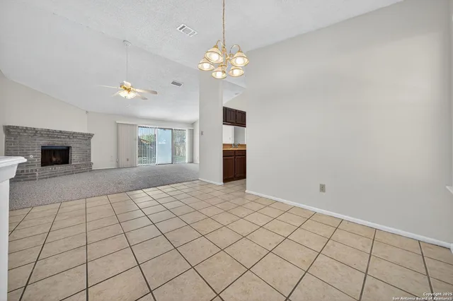 a living room with a fireplace furniture and a chandelier
