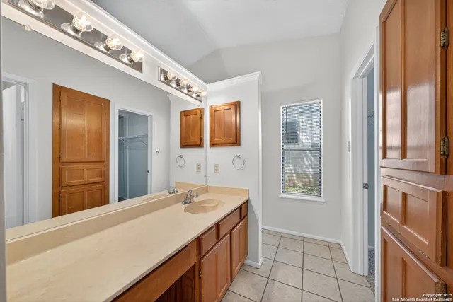 a bathroom with a granite countertop sink a mirror and a bathtub