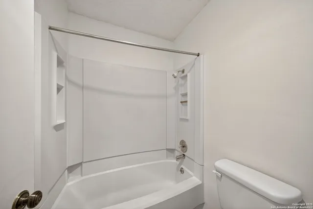 a bathroom with a toilet and a bathtub