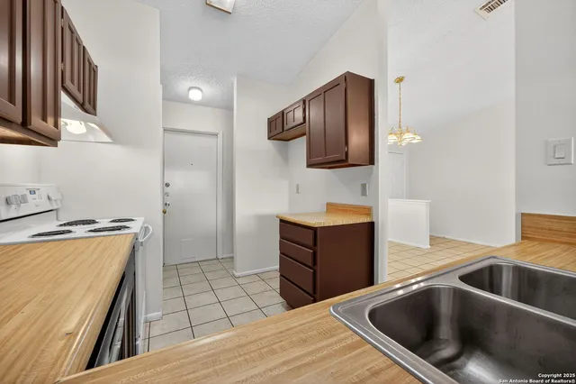 a kitchen with a sink and a stove top oven