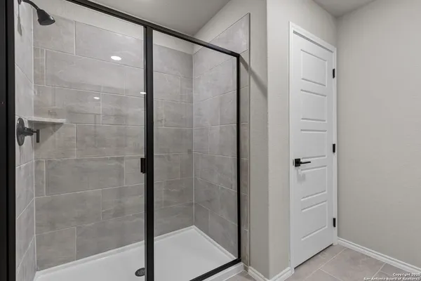 a bathroom with a glass shower door