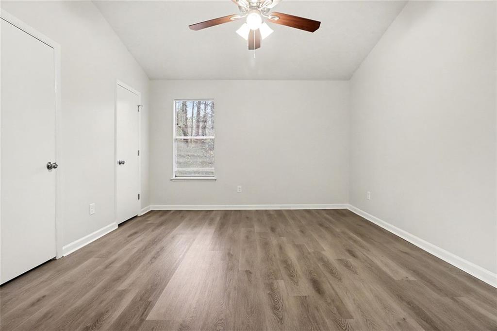 5474 Panola Downs Road Lithonia, GA 30058 - Photo 11 of 27 wooden floor in an empty room with a window