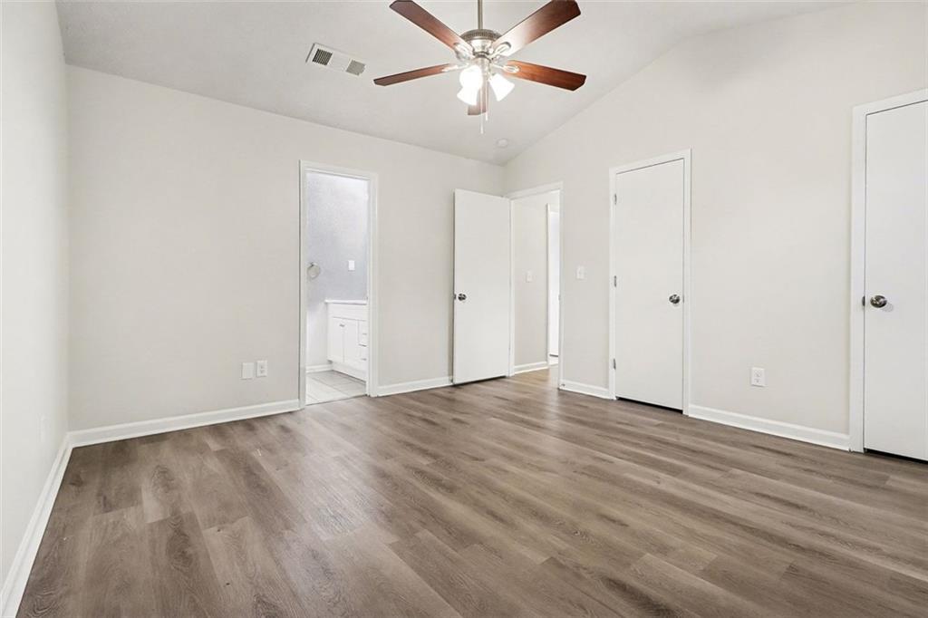 5474 Panola Downs Road Lithonia, GA 30058 - Photo 12 of 27 a view of an empty room with wooden floor