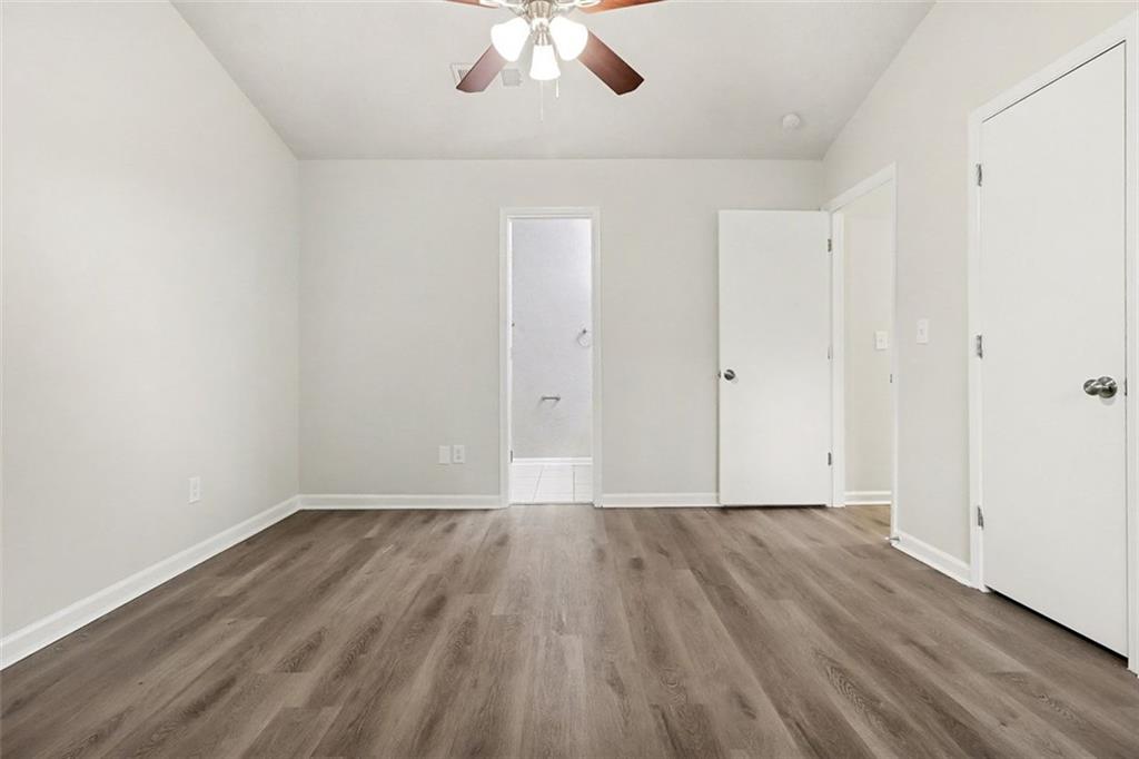 5474 Panola Downs Road Lithonia, GA 30058 - Photo 14 of 27 wooden floor in an empty room