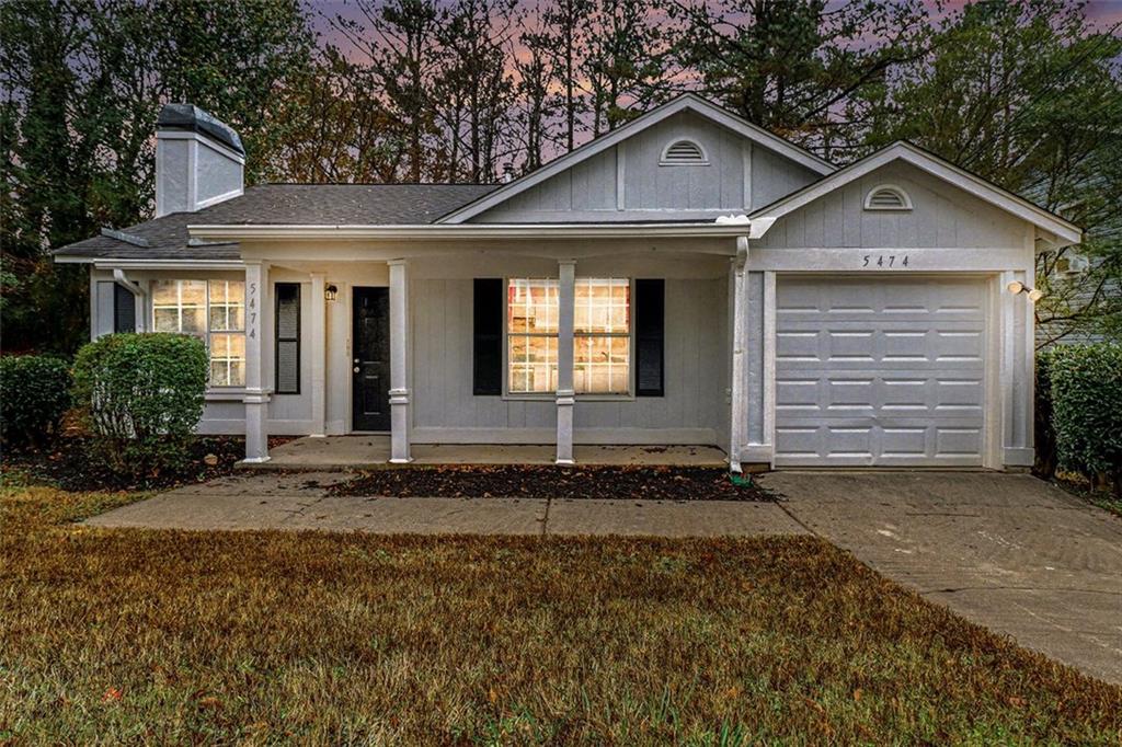 5474 Panola Downs Road Lithonia, GA 30058 - Photo 24 of 27 a front view of a house with a yard