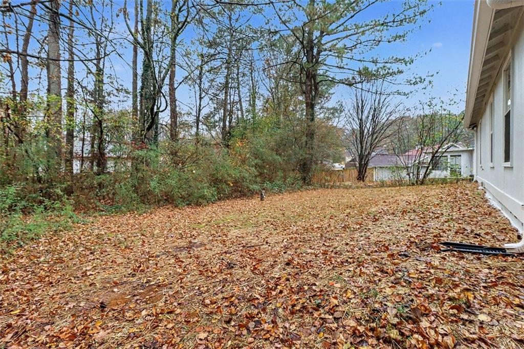 5474 Panola Downs Road Lithonia, GA 30058 - Photo 27 of 27 a view of a yard with trees