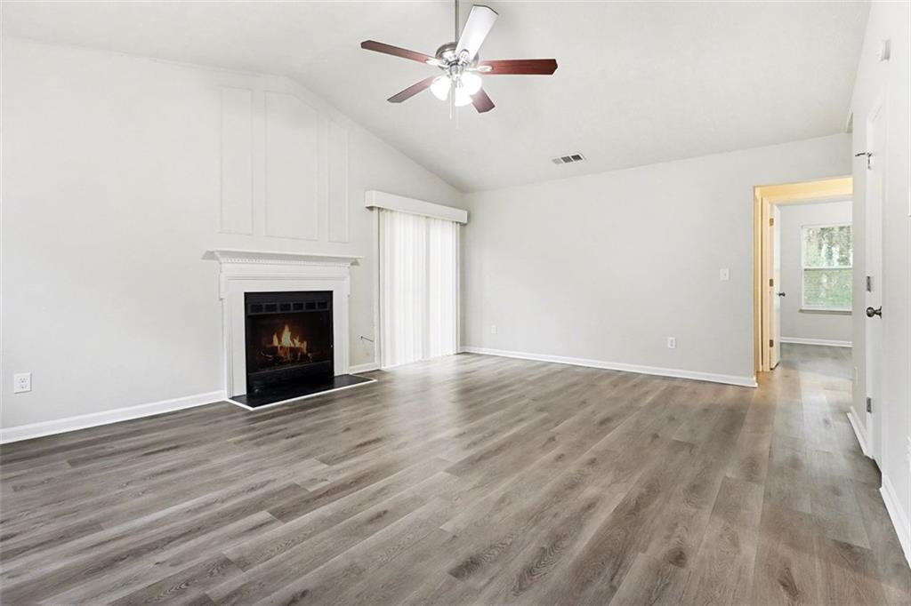 5474 Panola Downs Road Lithonia, GA 30058 - Photo 3 of 27 a view of empty room with wooden floor and fan