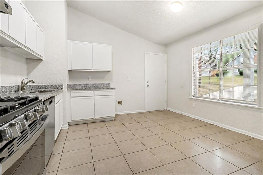 5474 Panola Downs Road Lithonia, GA 30058 - Photo 8 of 27 a kitchen with a stove a sink and a refrigerator