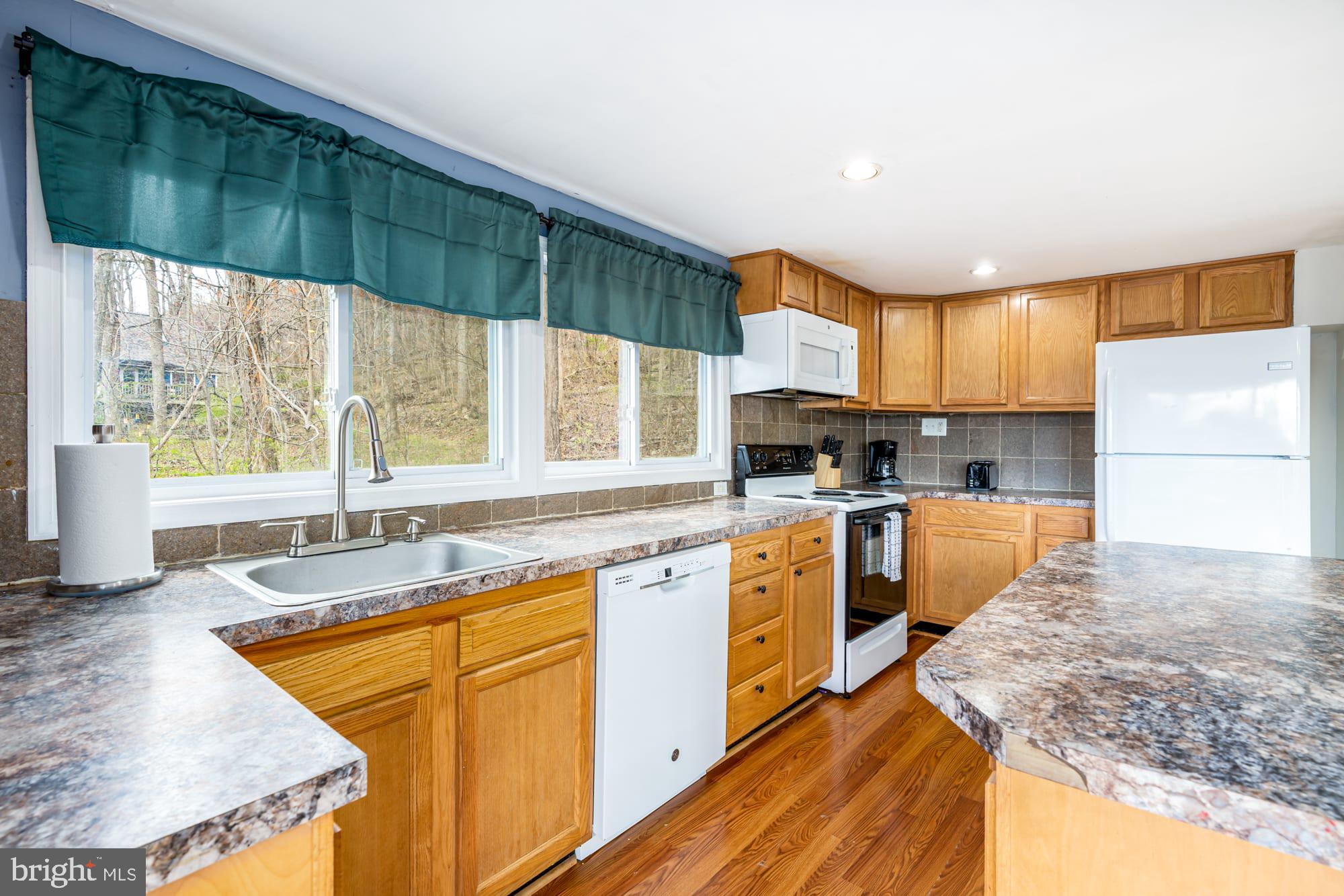 1125 Nancy Jack Road Gerrardstown, WV 25420 - Photo 11 of 24 a kitchen with stainless steel appliances granite countertop sink stove and cabinets