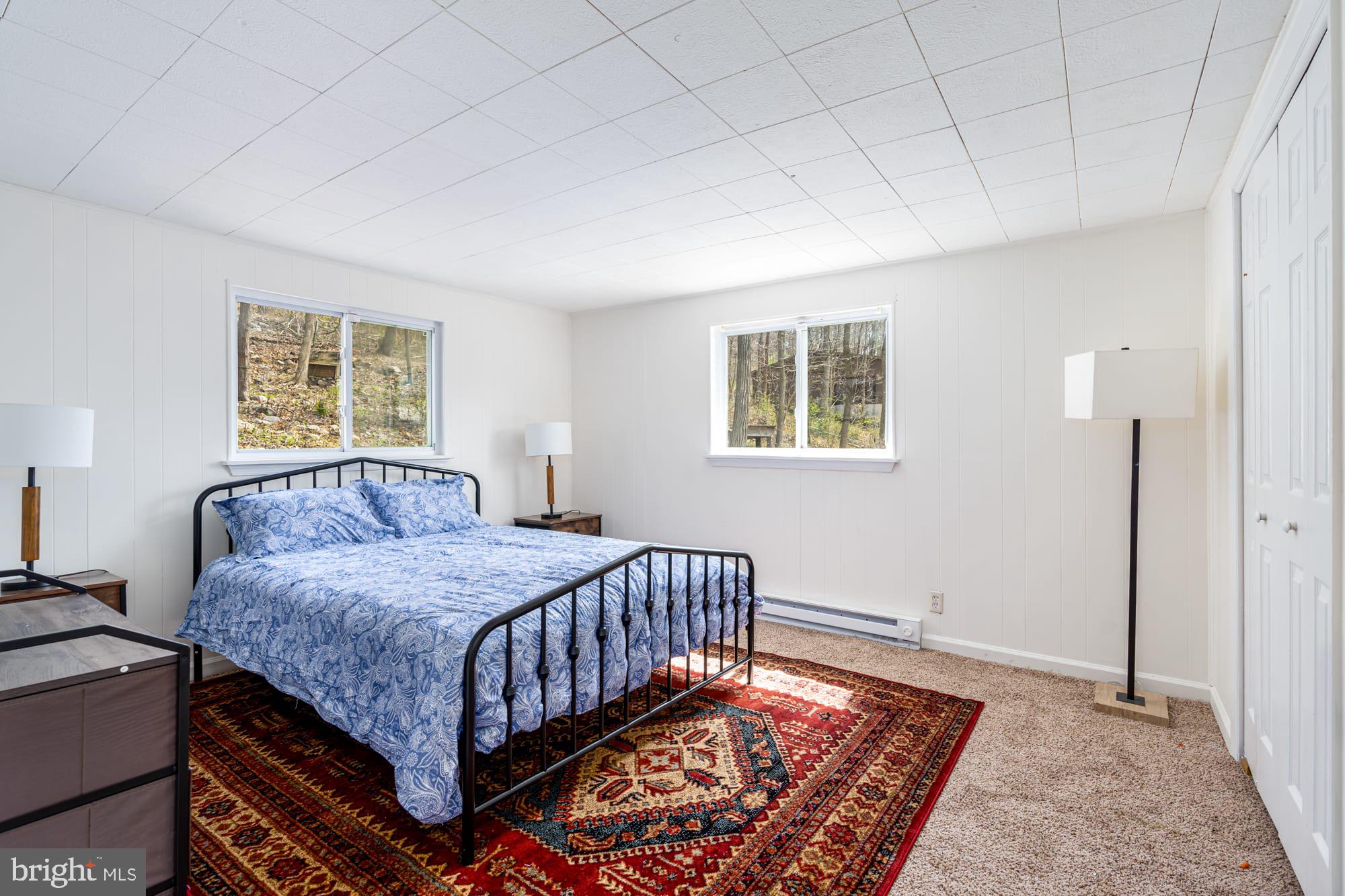 1125 Nancy Jack Road Gerrardstown, WV 25420 - Photo 15 of 24 a bedroom with a bed window and a table in it