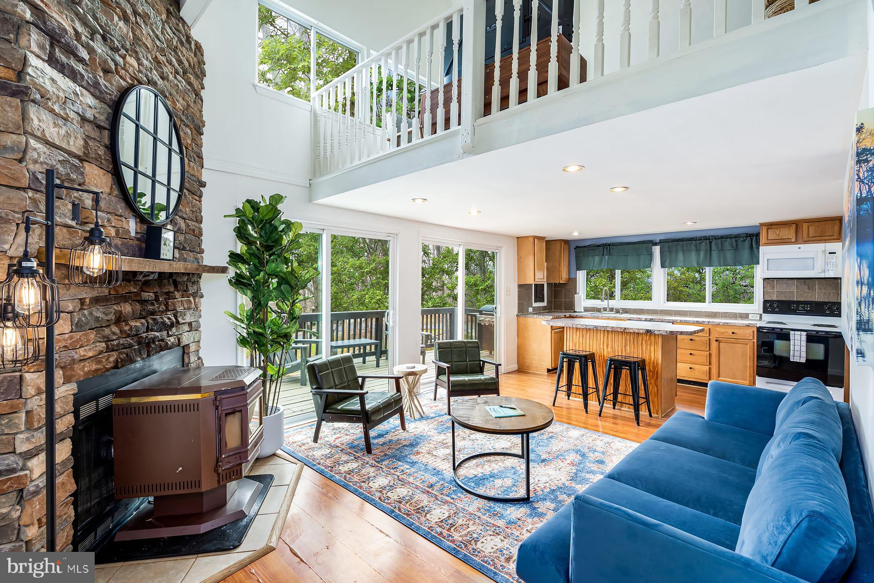 1125 Nancy Jack Road Gerrardstown, WV 25420 - Photo 2 of 24 a living room with fireplace furniture and a large window