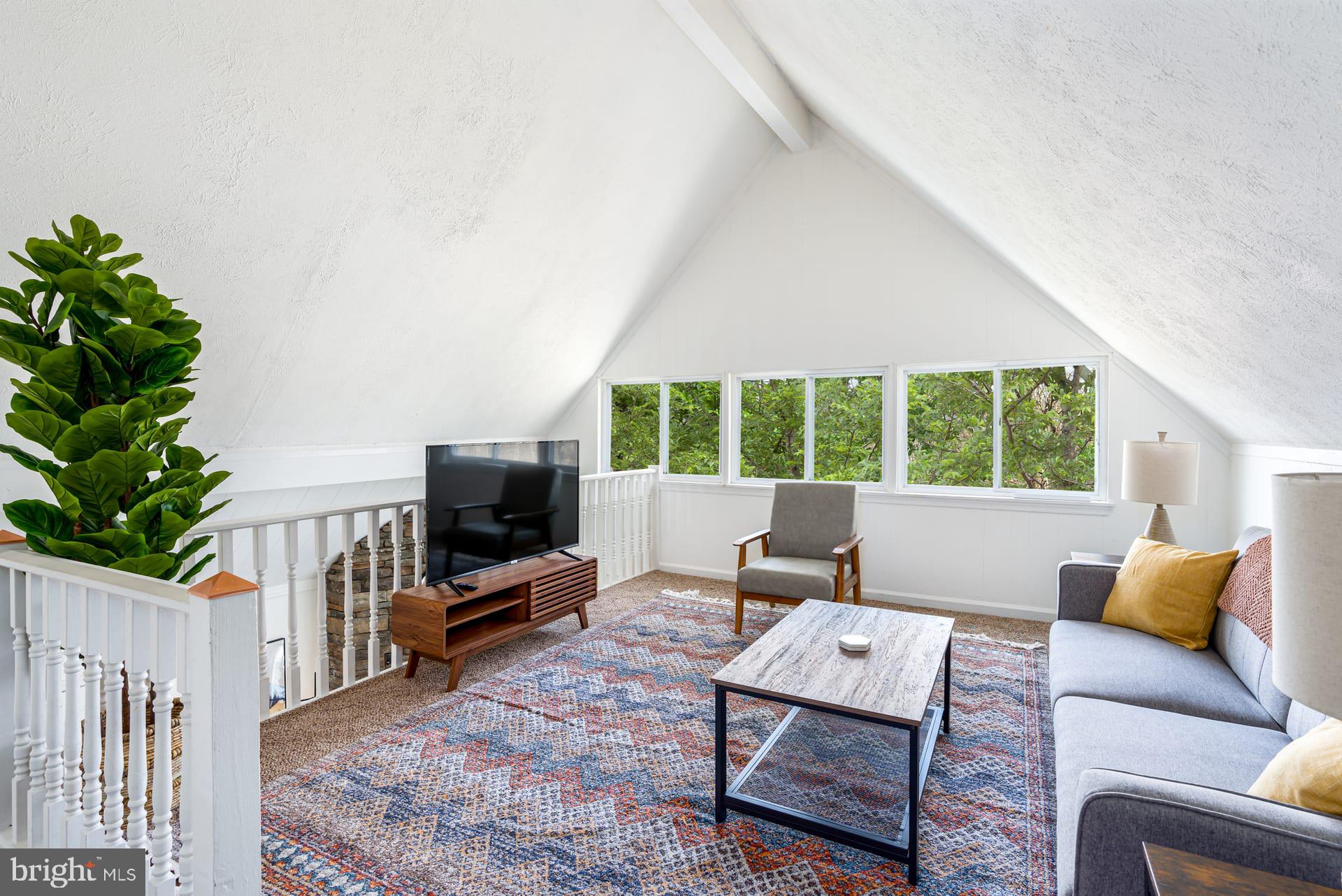 1125 Nancy Jack Road Gerrardstown, WV 25420 - Photo 4 of 24 a living room with furniture a flat screen tv and a large window