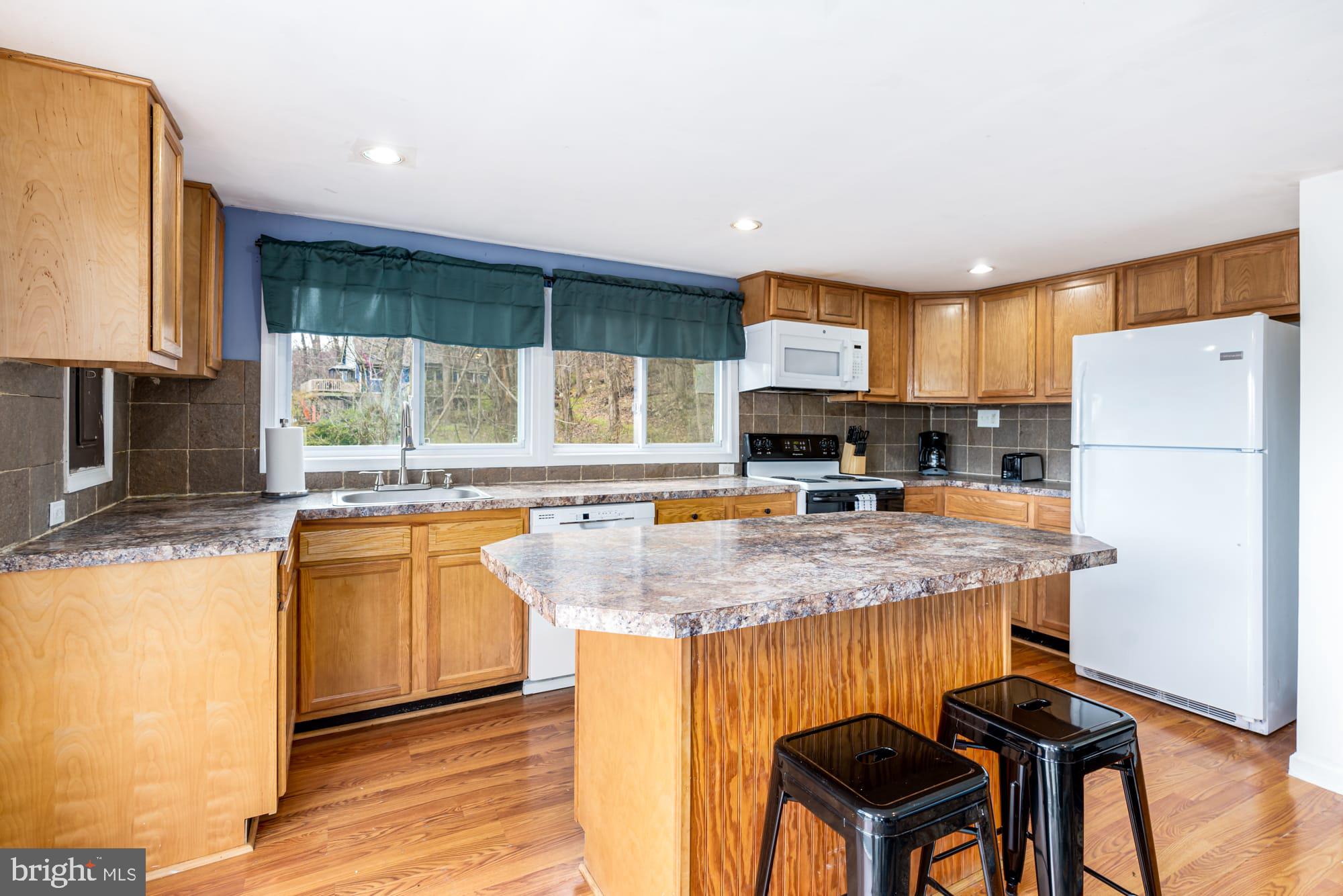 1125 Nancy Jack Road Gerrardstown, WV 25420 - Photo 9 of 24 a kitchen with stainless steel appliances granite countertop a sink refrigerator and microwave