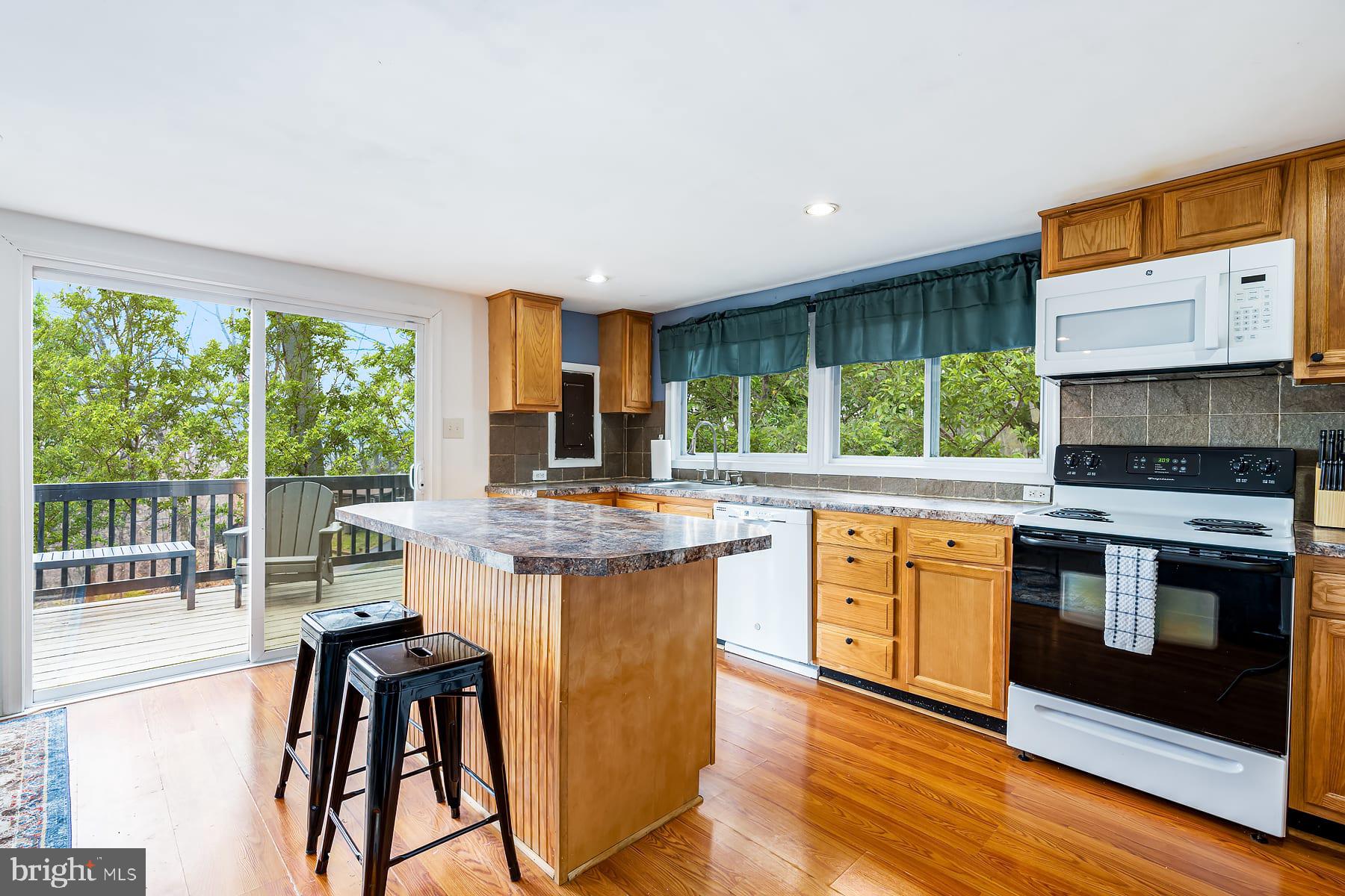 1125 Nancy Jack Road Gerrardstown, WV 25420 - Photo 10 of 24 a kitchen with stainless steel appliances granite countertop a stove a sink and a microwave